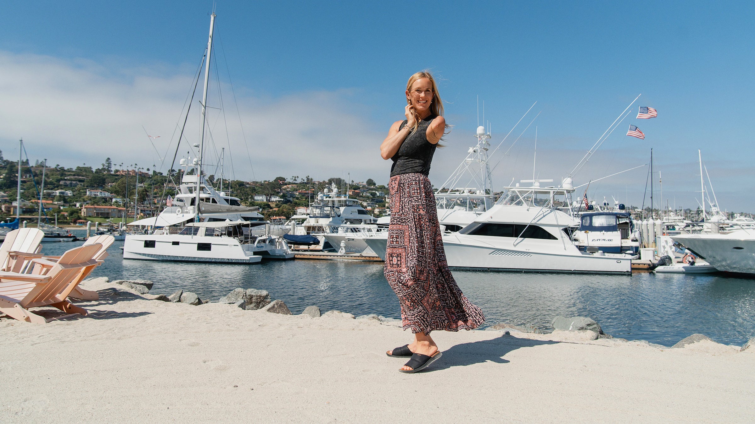 Bethany Hamilton wearing the Cobian Tolula Slide Black sandal on a beach at the Kona Kai Marina